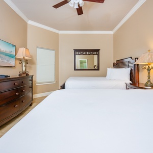 Drift into restful sleep on the queen beds, surrounded by soft light and calming coastal decor in this inviting guest room