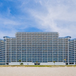 Experience stunning beachfront views from The Lighthouse in Gulf Shores with convenient parking and lush landscaping