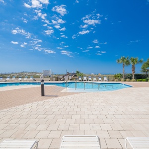 Enjoy the inviting pool area surrounded by lush greenery and comfortable lounge chairs for a relaxing day in the sun