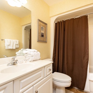 Freshen up in this guest bath in the relaxing shower or soothing tub before an exciting beach day