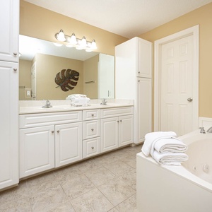 Indulge in relaxation in the master bath with a refreshing walk-in shower and soothing jetted tub
