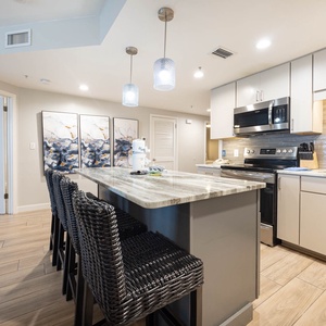 Gather around the sleek island with stylish seating, perfect for casual meals and enjoying time with loved ones