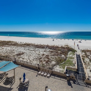 Relax on the spacious patio with shaded seating, just steps from the inviting shoreline and sparkling water