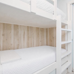 Kids will drift off in this bunk area tucked between soft wood paneling and bright white walls