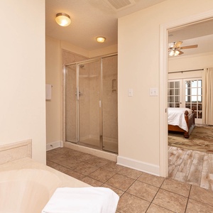 Refresh in the master bath after a day at the beach with a soothing jetted tub and relaxing walk-in shower