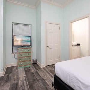 Brightly colored walls complement the guest room with two double beds, a playful dresser, and access to a nearby bathroom