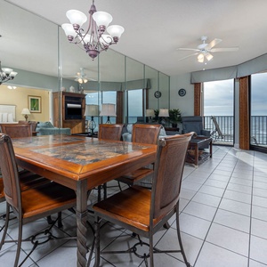 Gather around the wooden dining table, enjoying views and a spacious layout perfect for relaxation and meals together