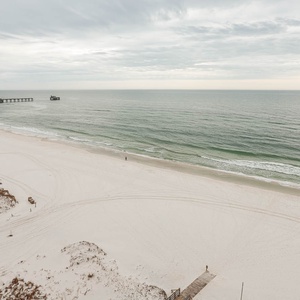 The spacious balcony features a stunning beachfront view, perfect for relaxation and enjoying the serene atmosphere
