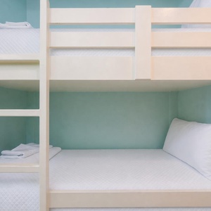 Cozy bunk beds in soft aqua walls offer a fun sleeping space for kids, with easy access to the inviting living area