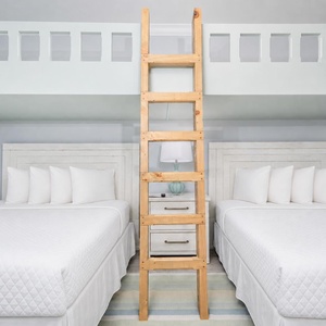 Cheerful guest bedroom featuring two queen beds below two lofted twin beds above, perfect for kids