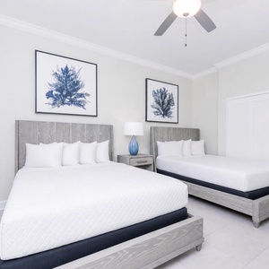 Relax on one of the cozy queen beds in this elegant guest suite and enjoy a peaceful slumber