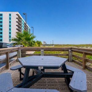 This inviting outdoor space is perfect for gathering with family and enjoying a meal in the coastal breeze