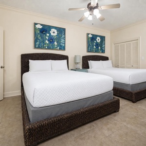 Sleep peacefully in this spacious guest room with two plush queen beds, vibrant artwork, and a cozy vibe