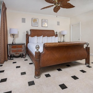 Experience restful nights in this elegant master bedroom featuring a king bed, stylish decor, and beach balcony access