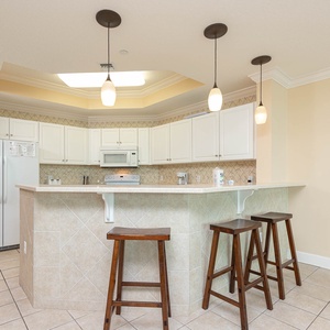 Gather your family at the cozy breakfast bar, enjoying coffee and laughter while overlooking the elegant kitchen space