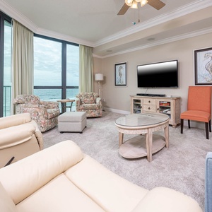 Relax in this inviting living area with a sofa and queen sleeper, a flat-screen TV, and beautiful views through large windows