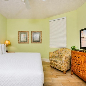 Enjoy relaxing in this king guest suite, with soothing decor and a cozy chair inviting you to unwind peacefully