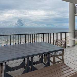 Relax on this balcony featuring a spacious table and comfortable seating for relaxing moments in the sun