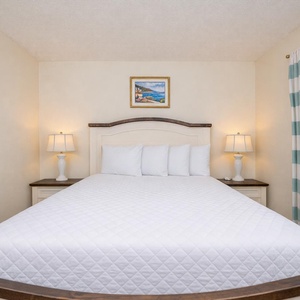 Enjoy a peaceful night in the master suite, embraced by soft bedding and gentle lighting for a relaxing getaway