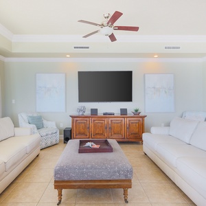 Unwind in the living room, surrounded by inviting decor, featuring a queen sleeper sofa and stylish accents