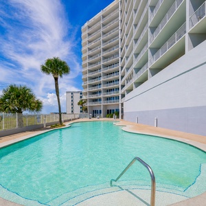 Relax by the pool with views of the beach, perfect for family fun and soaking up the sun