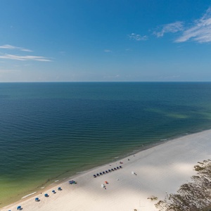 Feel the gulf breeze as you watch waves lap the wide beach and umbrellas dot the shore