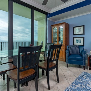 Enjoy meals at the glass dining table while taking in views through expansive windows in this inviting space