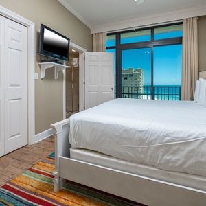 Relax on your king bed in this guest suite, letting the coastal views from the balcony elevate your vacation vibe