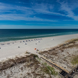 Serene view of the tranquil waters and inviting beach, perfect for sunbathing and relaxation