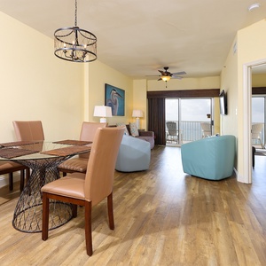 This inviting space features a stylish dining table, a comfortable seating arrangement, and a stunning beachfront view
