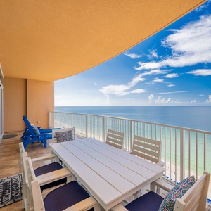 Dine al fresco at the spacious table, surrounded by vibrant decor and breathtaking views of the tranquil waters