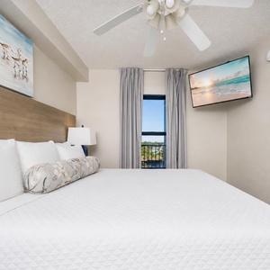 Fluffy pillows invite you to relax in the king suite for a calm movie night after a fun day at the beach