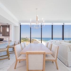 Gather around the elegant dining table with stunning beach views that invite relaxation and connection