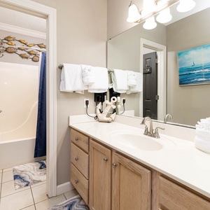 Refresh in this master bathroom, featuring a spacious vanity, decorative accents, and a relaxing tub-shower combination
