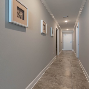 Walk down the tiled hall, admire framed coastal art, and relax with coastal vibes in your vacation rental