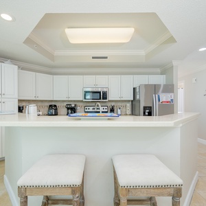 Gather around the breakfast bar, enjoying morning coffee while admiring the inviting kitchen design