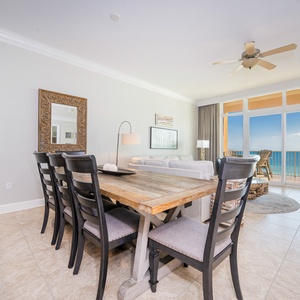 Gather around the rustic dining table, with views of the beach through expansive windows inviting relaxation
