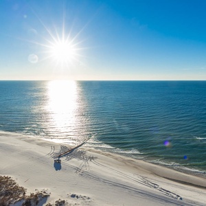 Step onto the balcony and feel the gulf breeze while sunlight sparkles on the shore below