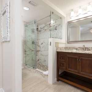 Refresh in this stylish master bath featuring a glass walk-in shower, elegant vanity, and modern fixtures