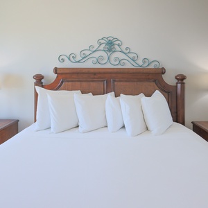 This bedroom features a beautifully crafted wooden bed with plush pillows and warm bedside lamps, perfect for restful nights