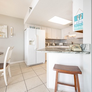 Gather around the round table under a chandelier, enjoying meals while admiring the stylish decor and open layout