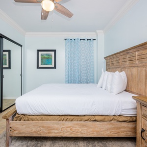 This guest bedroom features a comfortable bed, elegant decor, and a soothing blue color scheme, perfect for relaxation