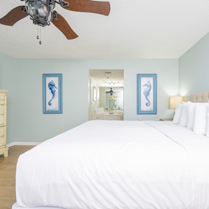 Experience restful nights in this inviting master bedroom with a king bed, coastal decor, and a TV