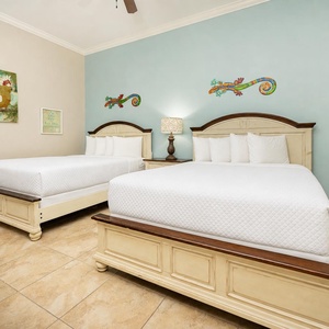 Rest in comfort on plush queen beds, where cheerful decor and calming vibes enhance your family getaway experience