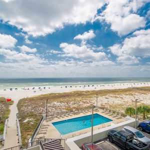 Enjoy a vibrant view of the beach and pool area, perfect for relaxing under the sunny skies