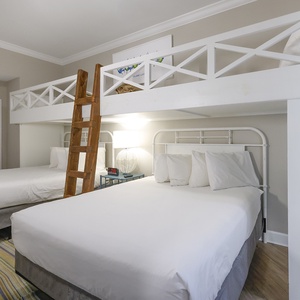 Sleep soundly in this charming bunk room with two lofted twin beds above two cozy queen beds below