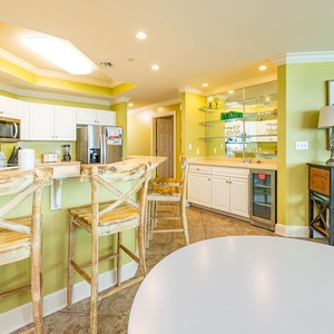 Rustic wooden stools line the bar where you pour cool drinks while sharing stories in your vacation rental