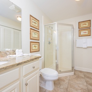 Additional bath featuring a walk-in shower, granite countertops, laundry area with washer/dryer and charming fish artwork