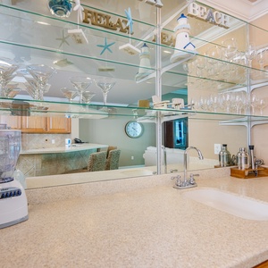 Mix your favorite drinks at the wet bar while enjoying the beach-inspired decor surrounding you