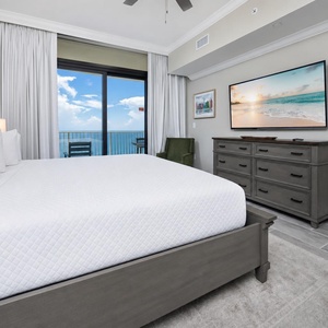 Relax in this inviting master bedroom with a king bed, large TV, and the sights and sounds of the gulf coast
